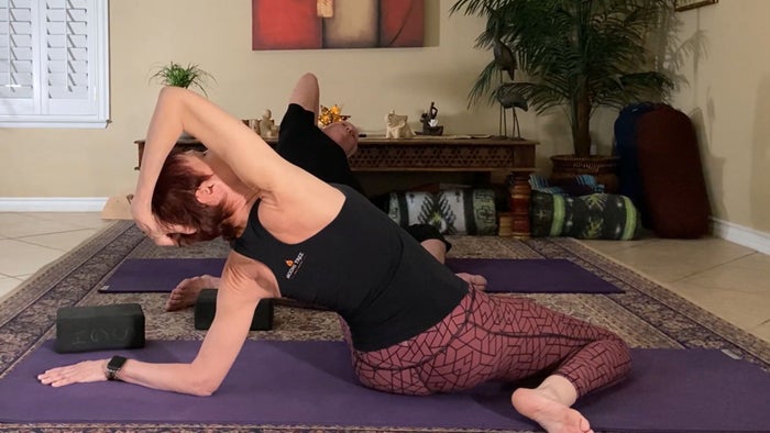 A man and woman doing yoga exercise at home