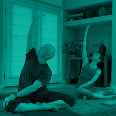 A couple doing yoga at home