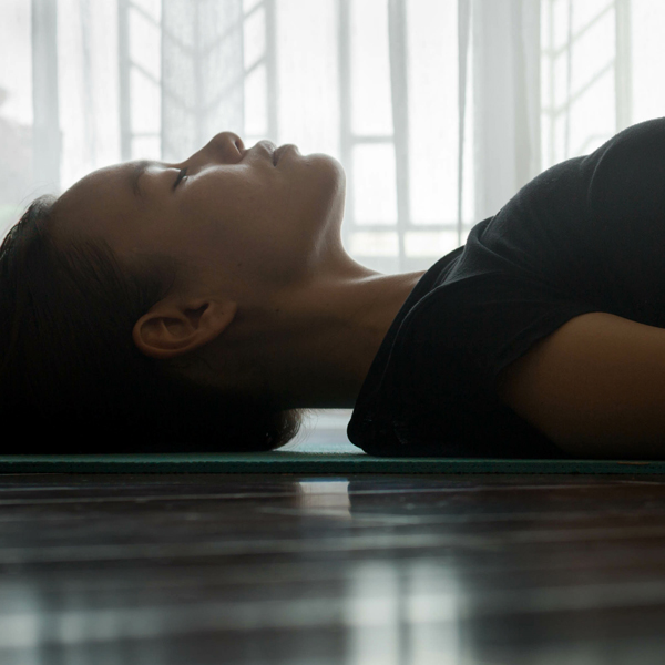 A woman's head lying in a yoga mat